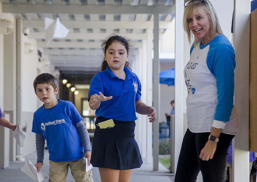 Chantal Sainz throws her paper airplane in the airplane toss portion of the Measurement Olympics.