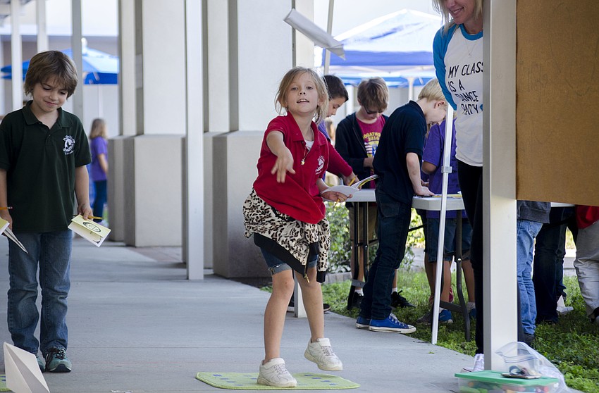 Michelle Bettis throws her paper airplane in the airplane toss portion of the Measurement Olympics.