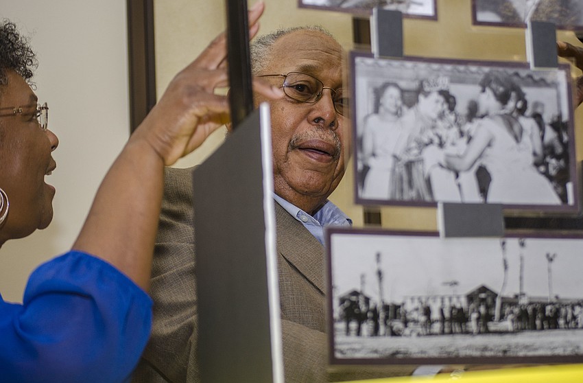 James Brown looks at historical photos before the unveiling of the 15 historical markers.