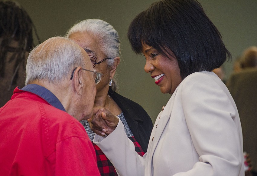 Vickie Oldham greets community members at the unveiling of Newtown'    s historical markers.