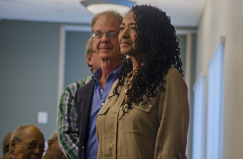 Rosalyn Howard and Chris Wenzel stand to be recognized for their work on the Newtown Alive project.