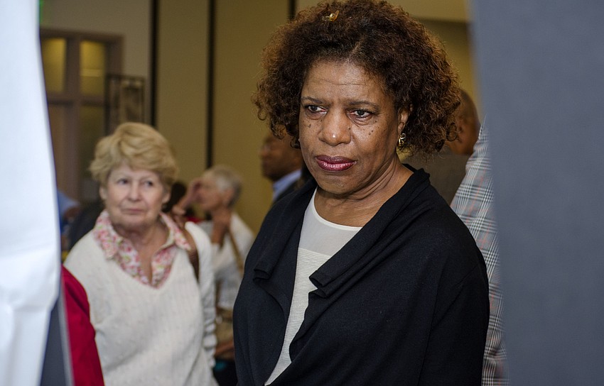 Mary Christian reads one of the 15 historic markers revealed during the ceremony.