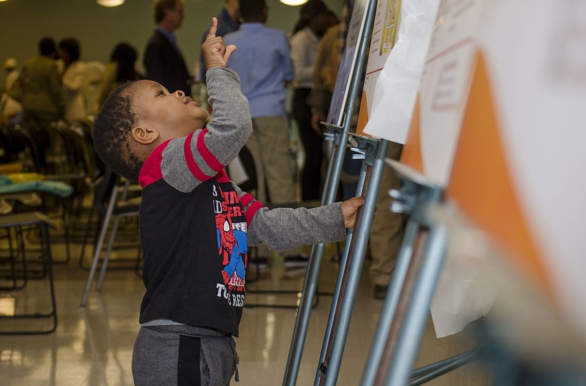 Muhammad Ngner looks up at one of the markers revealed Feb. 18 at the Robert L. Taylor Community Complex.