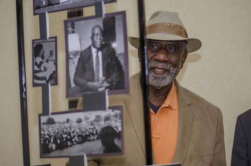 Former Sarasota Mayor Fredd Atkins looks at historical photos before the unveiling of the 15 historical markers.