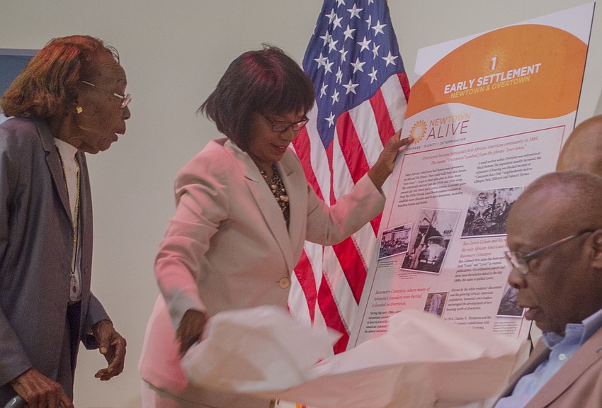 Vickie Oldham reveals one of the historic markers that will placed throughout Newtown.