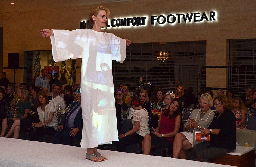 The show opened with a special multimedia fashion piece that incorporated art projected onto a white garment.
