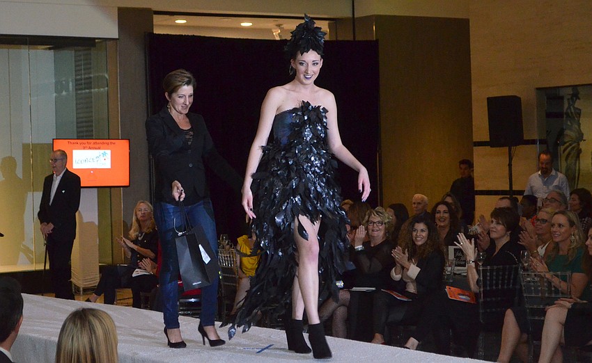 Top three juror’s pick winner Traci Kegerreis accompanies daughter Maezie Kegerreis on the runway as she models “Ing’s Raven” a second time.