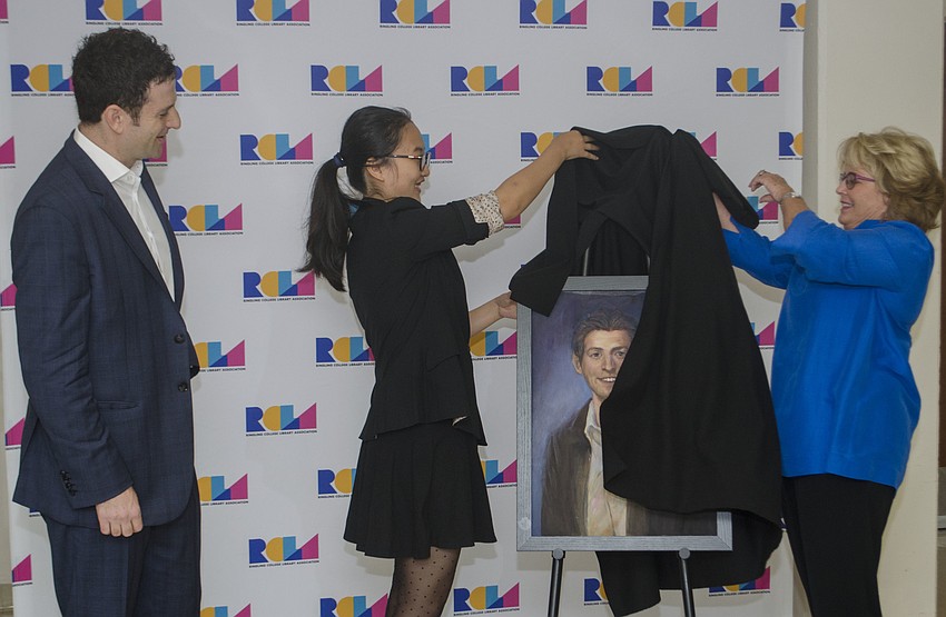 Renee Eppard helps student artist JingJing Cao reveal her portrait of Jared Cohen.