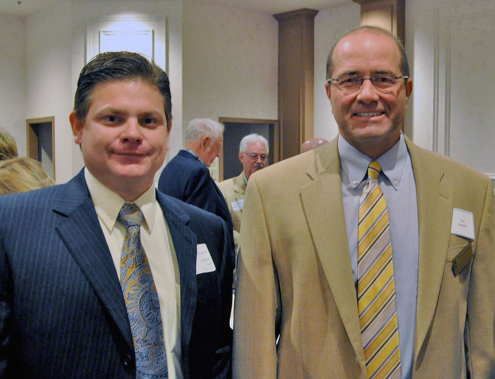 North Port City Manager Jonathan Lewis and Sarasota County Administrator Tom Harmer pose at a 2012 Tiger Bay Club meeting. This summer they may be working together.