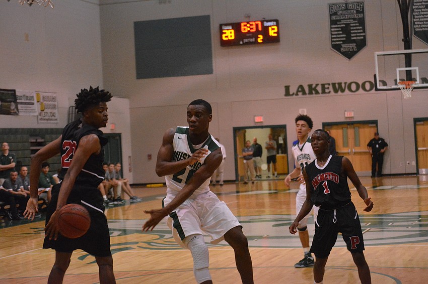 Devin Twenty makes a pass in the paint.