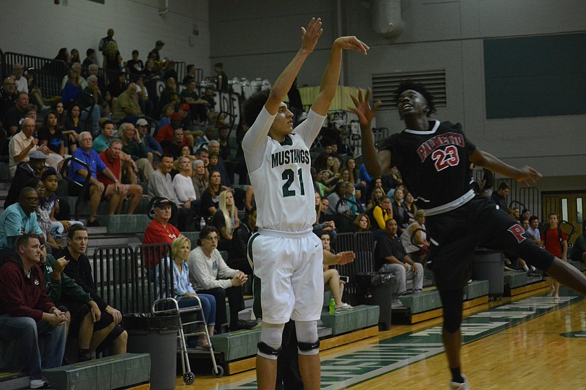 Evan Spiller launches a three-pointer.