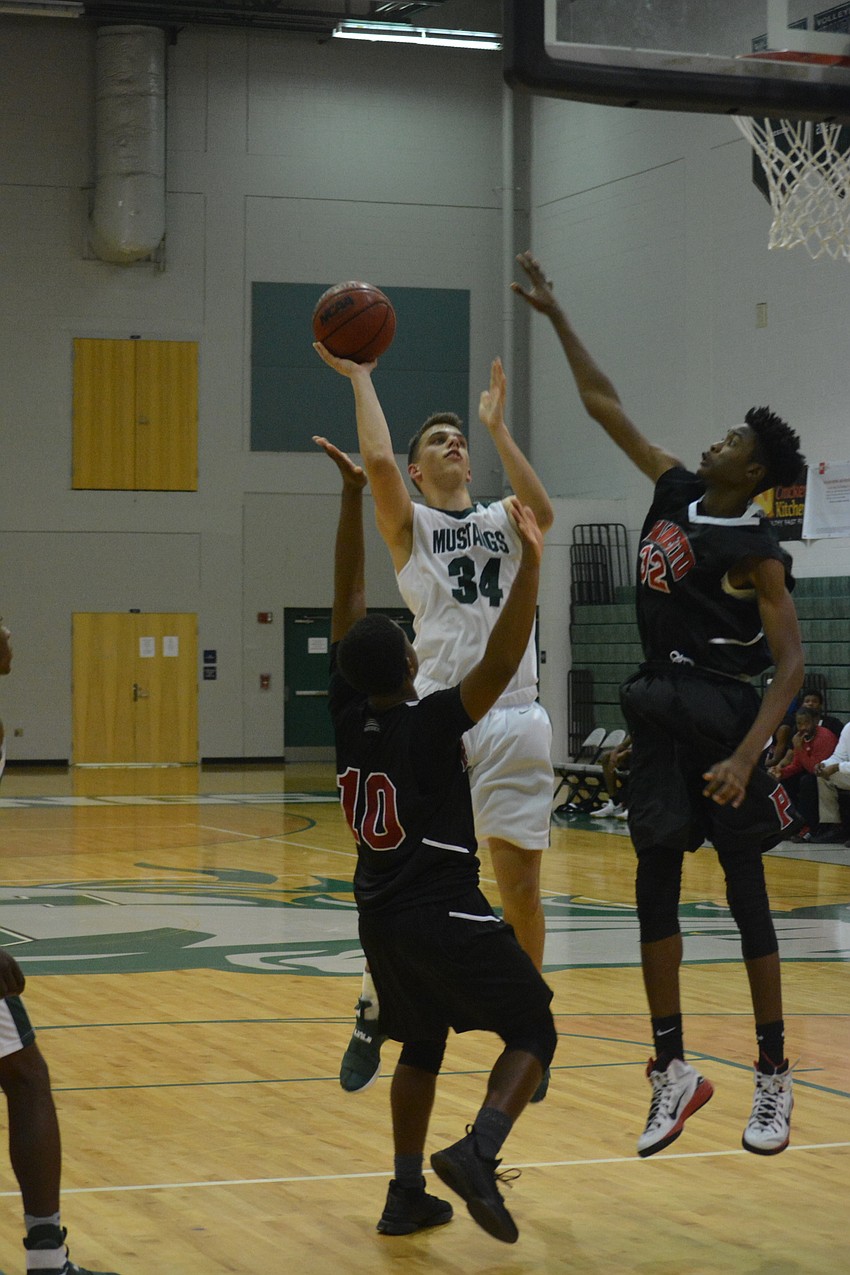 Jack Kelley hits a shot over two defenders.