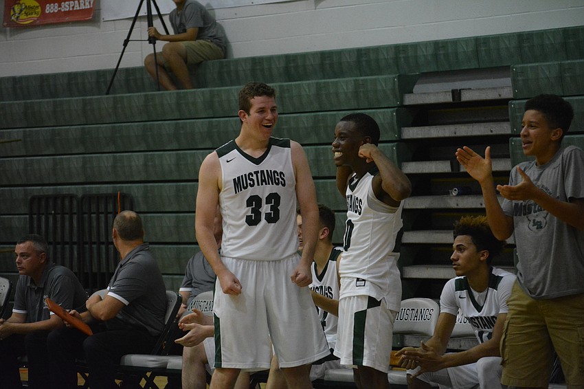 Justin Muscara and Devin Gordon celebrate Sam Jackson hitting an 
