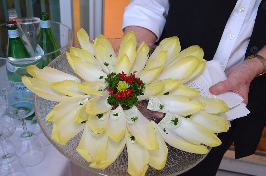 Laura Pruitt serves her endive and herb cheese hors d’oeuvre.