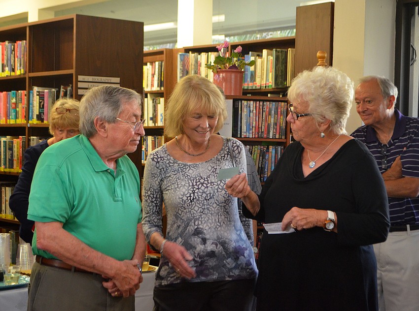 Hazel Steskal gives Bob and Pat Gussin a lifetime membership to the library.