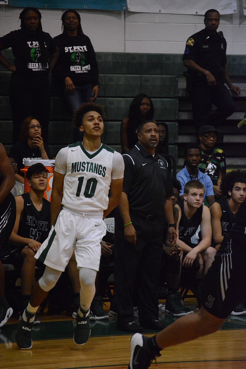 Damien Gordon watches his three-pointer swish through the net.