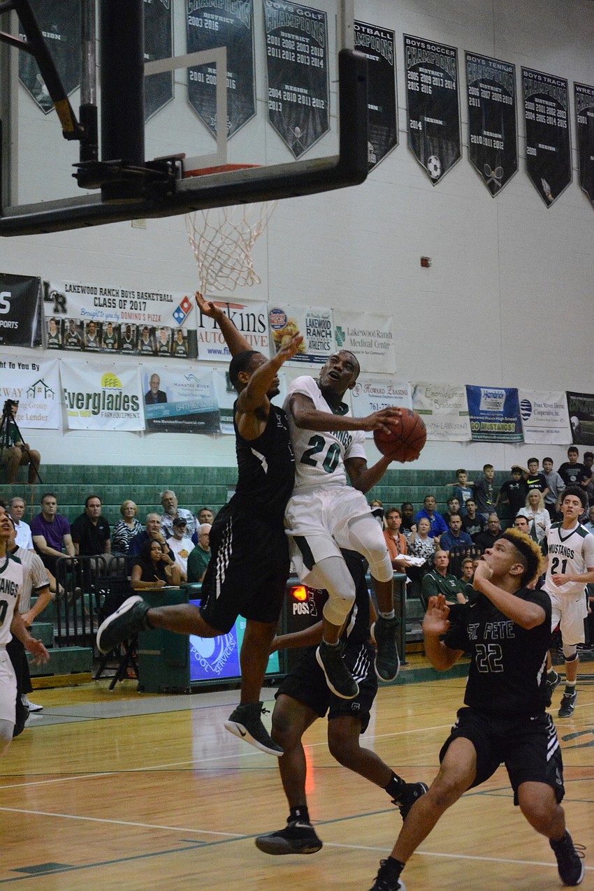 Devin Twenty takes contact in the air.