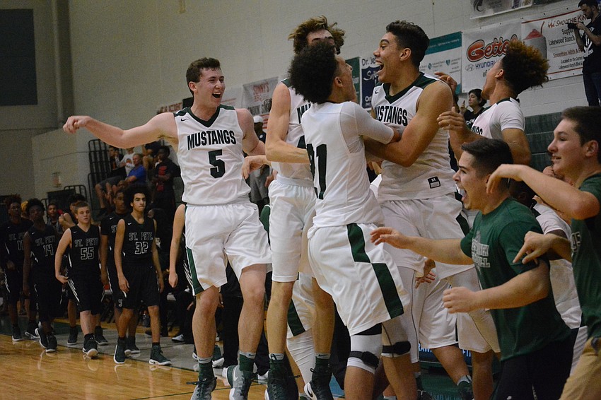 The Mustangs burst into elation as the horn sounds.