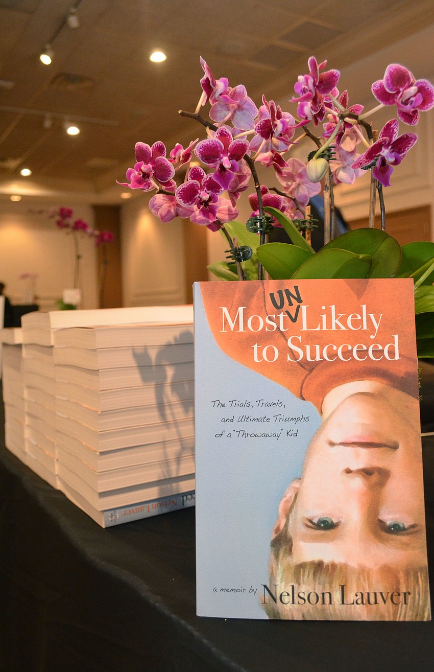Nelson Lauver signed copies of his book, “Most Unlikely to Succeed,” at the luncheon on Feb. 24 at Michael’s On East.