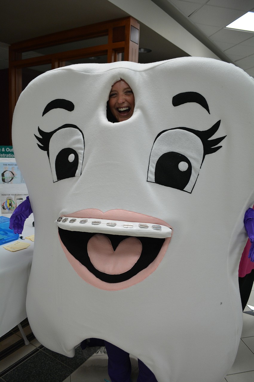 Carrie Betts smiles big as the super tooth from Moricz and Barone Orthodontics.