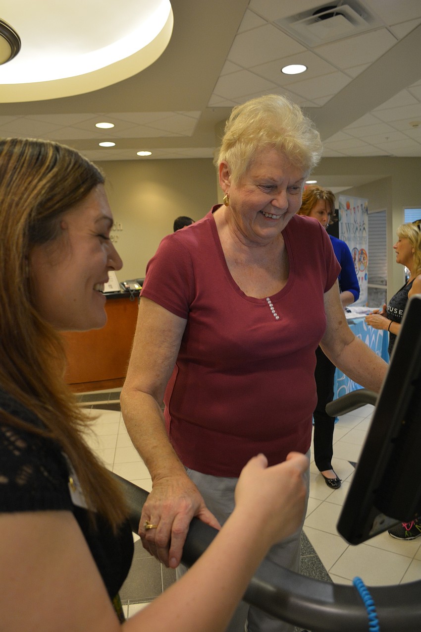 Jessie Daily, of Hawthorne Village Healthcare and Rehab, checks the balance of Loretta Zack, of Central Park.
