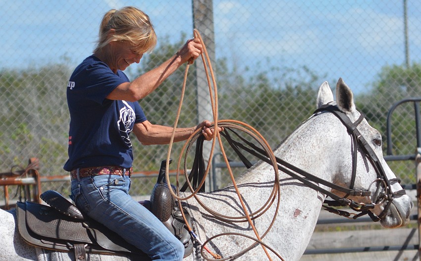 Sally Miller, representing the polo players, tries to figure out the lariat.