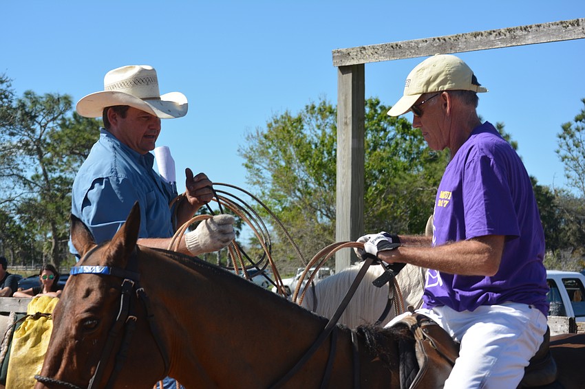 Steve John tries to give Dixon Stroud, representing the polo players, some tips about roping.