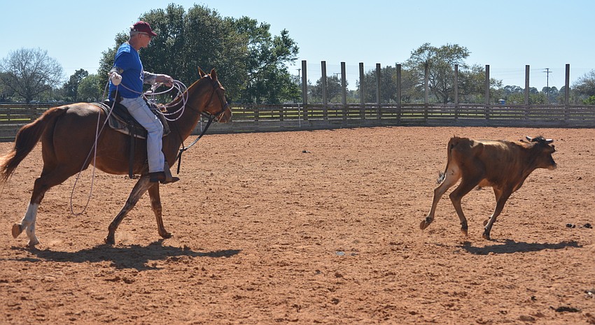 Kit Reid, representing the polo players, tries his hand at roping a steer.