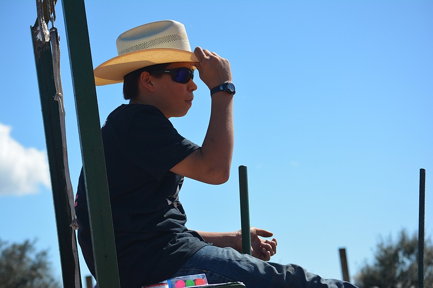 Levi Jaglie has one of the easier jobs, pulling the handle which released the steers.