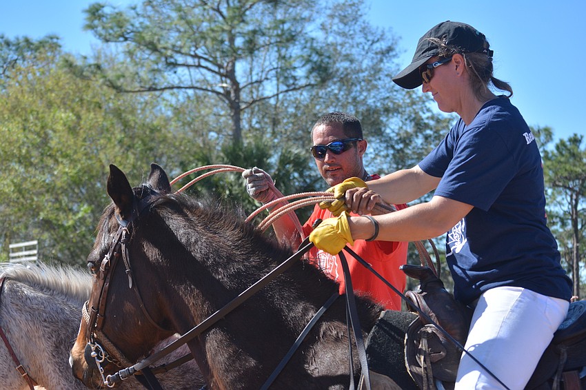 Pancho Davis, a skilled cowboy, gives some tips to polo player Holly Chamberlain.