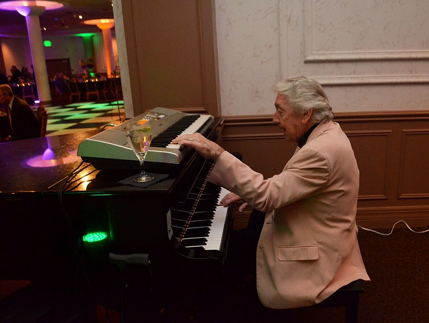 George Luther played the piano during the cocktail hour of Bethesda House Mardi Gras Madness.