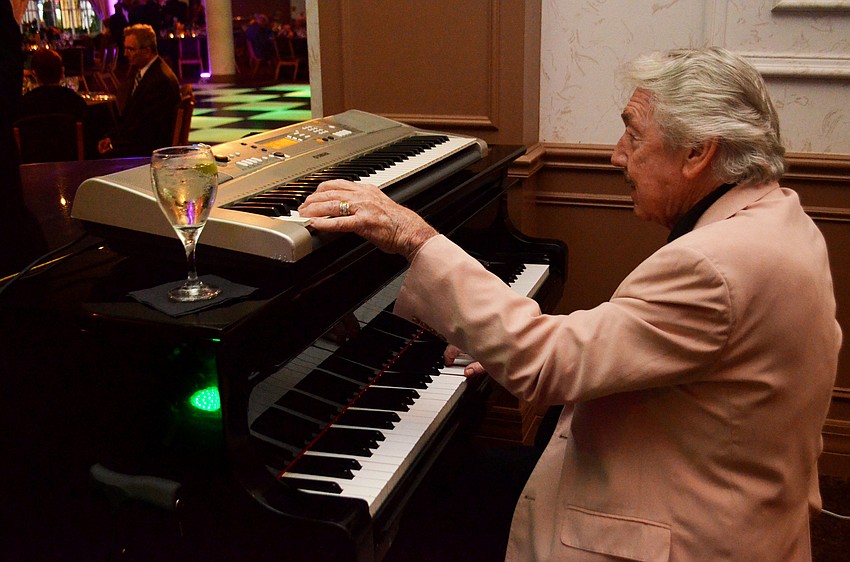 George Luther played the piano during the cocktail hour of Bethesda House Mardi Gras Madness.