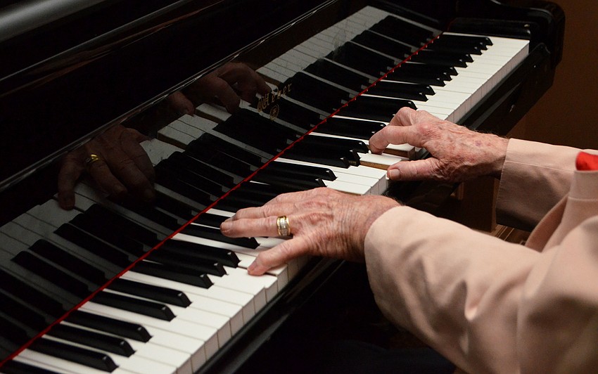 George Luther played the piano during the cocktail hour of Bethesda House Mardi Gras Madness.