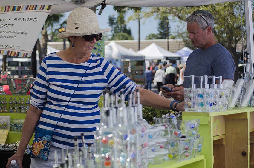 Marilyn Graves browses a booth at the Siesta Key Craft Festival.
