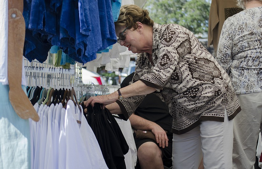Sue Shapero browses in a booth at the Siesta Key Craft Festival