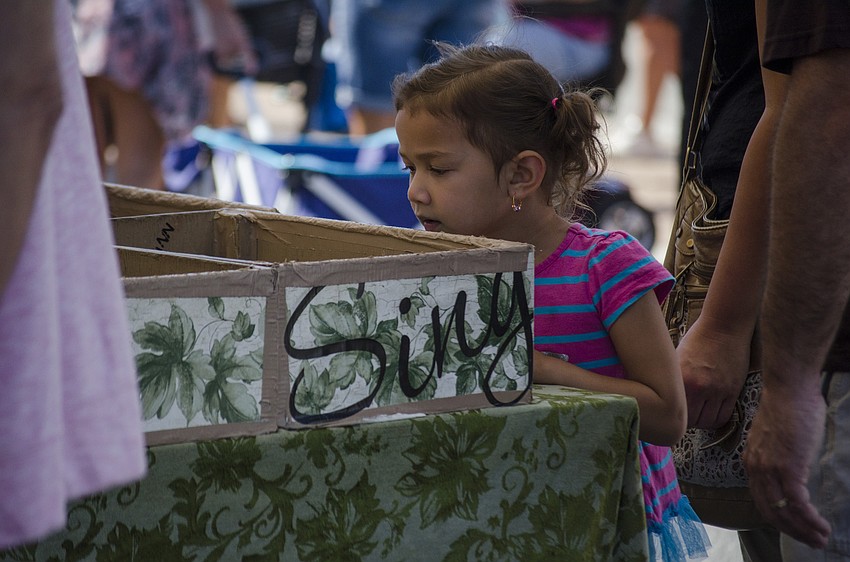 Nili Elan looks into a box of handmade ceramics.