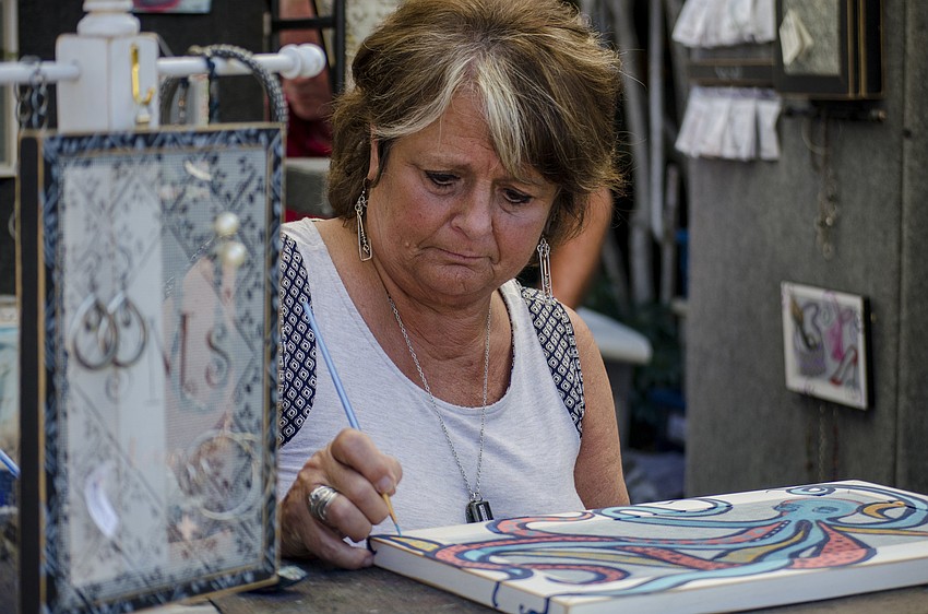 Barabara Downey works on a piece during the Siesta Key Craft Festival.