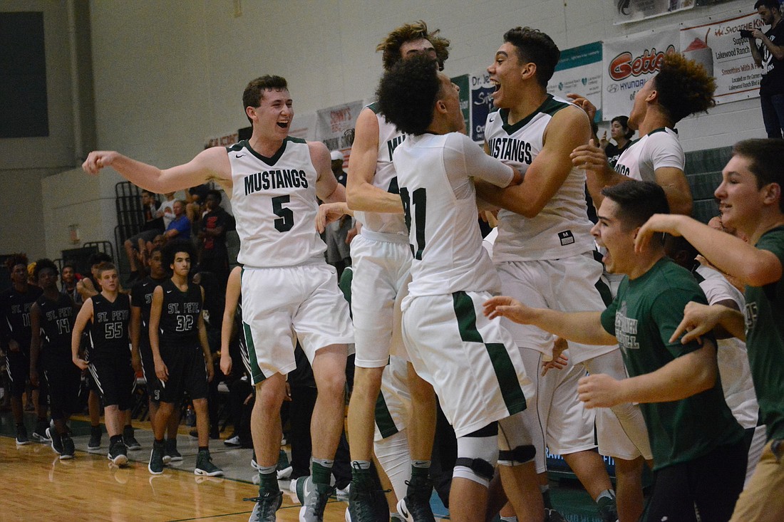 The Mustangs burst into elation as the horn sounds against St. Petersburg.