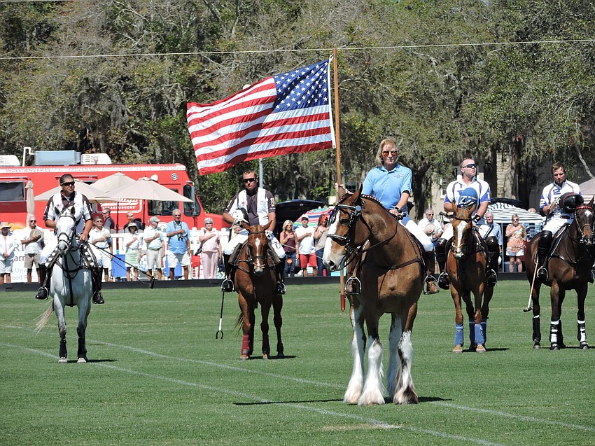 Dana Aschinger, a Polo Club member, presents the colors before the Observer Cup.