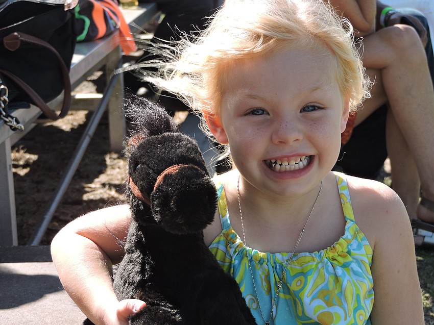 St. Petersburg'  s Caroline Cubler, 5, brought her own horse to the polo match.