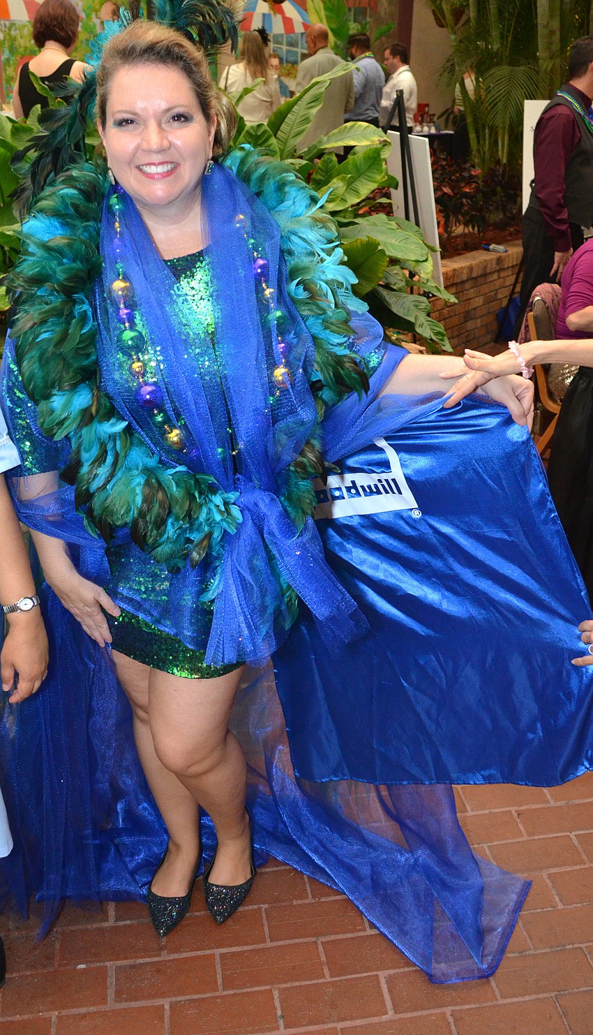 Foundation Vice President at Goodwill Manasota Veronica Brandon Miller shows off her Goodwill cape serving as a train for her dress at the Mardi Gras Gala on Feb. 28 at Michael’s On East.