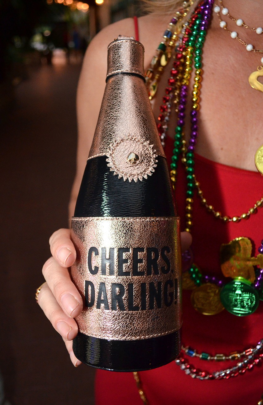 Amanda Morris donned a champagne bottle-shaped purse at the Mardi Gras Gala on Feb. 28 at Michael’s On East.