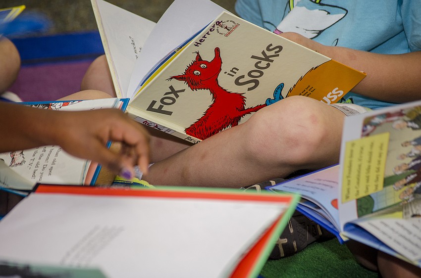 Children read Dr. Seuss books to commemorate his birthday on March 2.