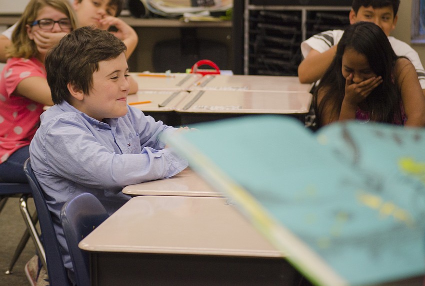 John Turchon laughs as Caroline Zucker reads.