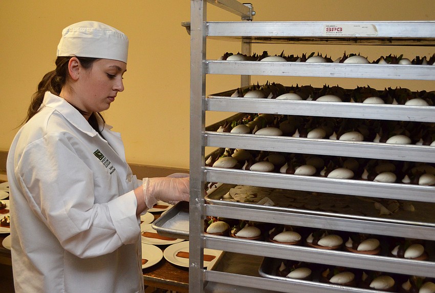 USF student Reenada Khair plates desserts for the guests at HospitaBull on March 2 at The Ritz-Carlton, Sarasota.