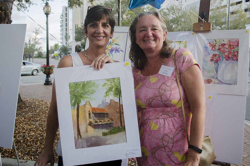 Janet Goddard poses with Amy Harding. Goddard had just purchased one of Harding'   s submissions to the sale.