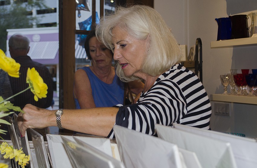 Diane Stable peruses art at the Sarasota Urban Sketchers event at Malbi Decor.