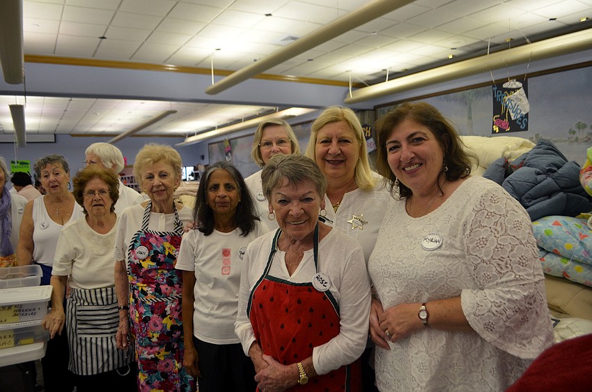 Members of the Women’s Guild work the linens table. The guild is responsible for organizing and preparing the Royal Rummage Sale.