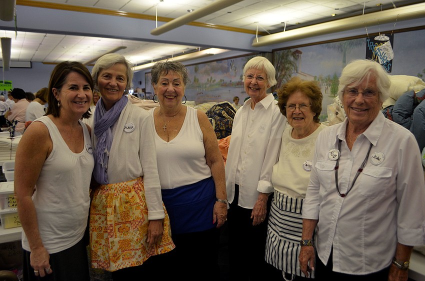 Members of the Women’s Guild work the linens table. The guild is responsible for organizing and preparing the Royal Rummage Sale.
