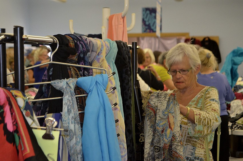 Therese Perron peruses the scarves at the early bird sale on March 3.